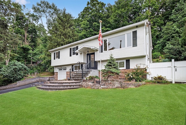 12 Valley Ln, Garrison, NY 10524 - split foyer home with a garage, asphalt driveway, and stone siding