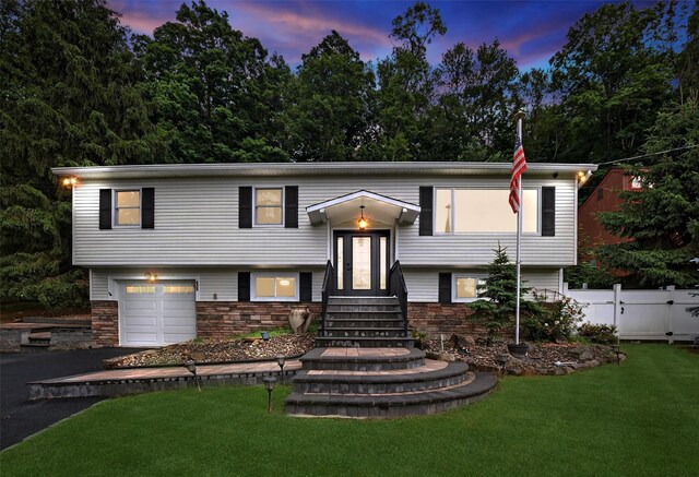 12 Valley Ln, Garrison, NY 10524 - bi-level home featuring stone siding, asphalt driveway, and a garage