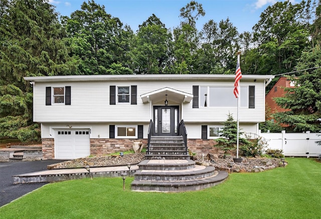 12 Valley Ln, Garrison, NY 10524 - split foyer home featuring asphalt driveway, stone siding, and a garage