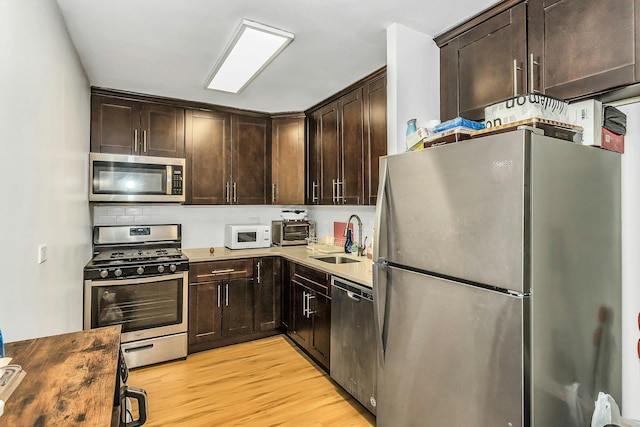 2 Bay Clb Unit 11F, Bayside, NY 11360 - kitchen with stainless steel appliances, dark brown cabinets, and light wood-type flooring