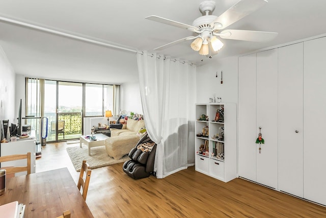 2 Bay Clb Unit 11F, Bayside, NY 11360 - living room featuring light wood finished floors, a ceiling fan, and a wall of windows