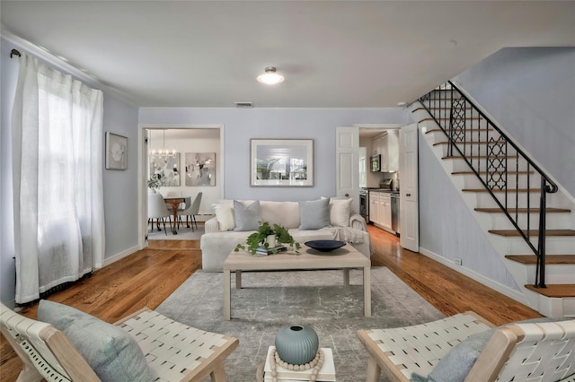 10 Cross St, Port Washington, NY 11050 - living room featuring stairs, wood finished floors, a chandelier, and crown molding