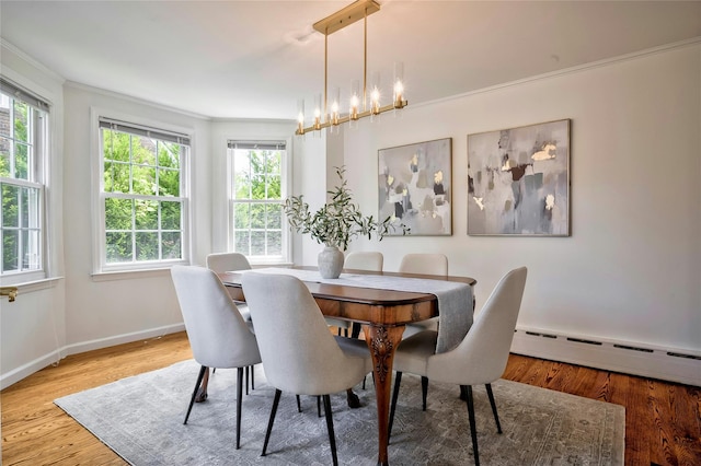 10 Cross St, Port Washington, NY 11050 - dining area featuring a baseboard radiator, ornamental molding, plenty of natural light, wood finished floors, and a chandelier