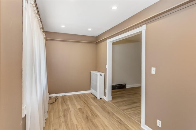 6739 Cooper Ave, Glendale, NY 11385 - unfurnished room featuring light wood-style flooring, recessed lighting, and radiator heating unit