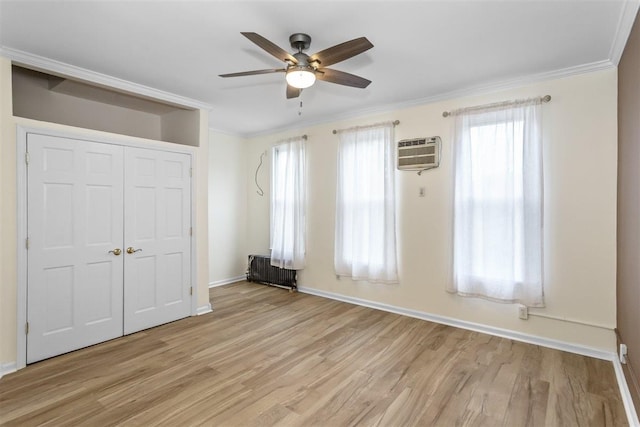 6739 Cooper Ave, Glendale, NY 11385 - unfurnished bedroom with crown molding, light wood-style floors, a wall mounted air conditioner, radiator, and a closet