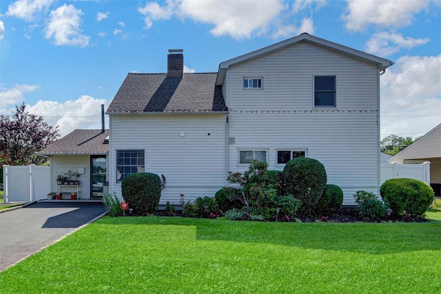 50 Apollo Ln, Hicksville, NY 11801 - rear view of house with a chimney and roof with shingles