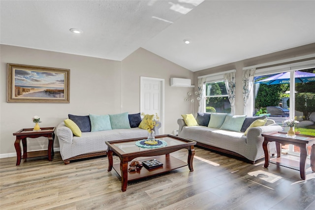 50 Apollo Ln, Hicksville, NY 11801 - living area featuring a wall unit AC, light wood-type flooring, vaulted ceiling, and recessed lighting