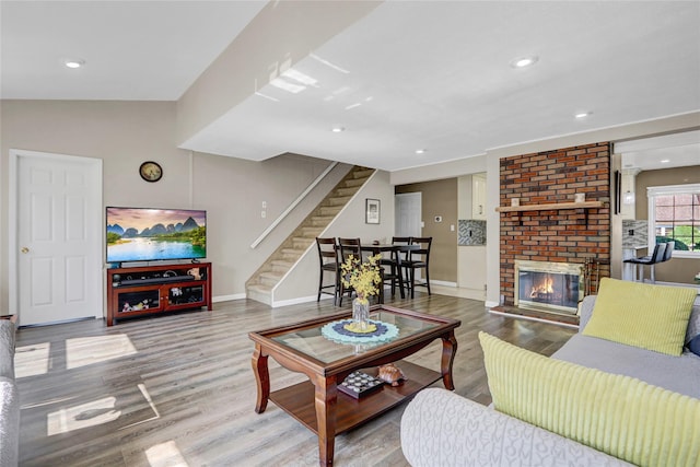 50 Apollo Ln, Hicksville, NY 11801 - living room featuring stairway, wood finished floors, recessed lighting, and a brick fireplace