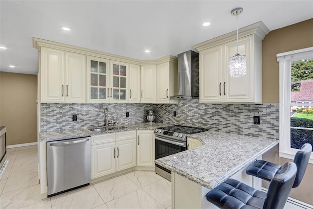 50 Apollo Ln, Hicksville, NY 11801 - kitchen featuring stainless steel appliances, wall chimney range hood, cream cabinetry, light stone countertops, and recessed lighting