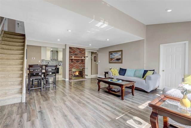 50 Apollo Ln, Hicksville, NY 11801 - living room featuring wood finished floors, stairs, recessed lighting, and a brick fireplace