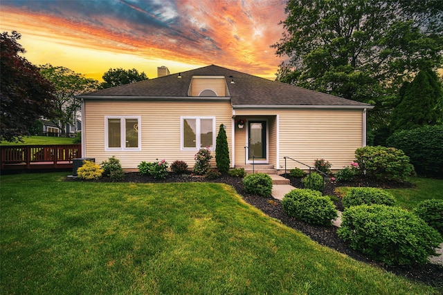 125 Fairways Cres, Carmel, NY 10512 - view of front of property featuring a yard, a chimney, a shingled roof, and a wooden deck