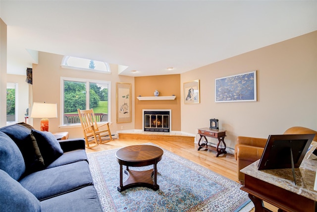 125 Fairways Cres, Carmel, NY 10512 - living room featuring healthy amount of natural light, wood finished floors, and a glass covered fireplace