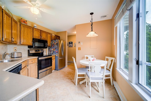 125 Fairways Cres, Carmel, NY 10512 - kitchen featuring black appliances, decorative backsplash, light countertops, brown cabinetry, and pendant lighting