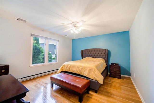 125 Fairways Cres, Carmel, NY 10512 - bedroom featuring baseboard heating, light wood-style floors, and a ceiling fan