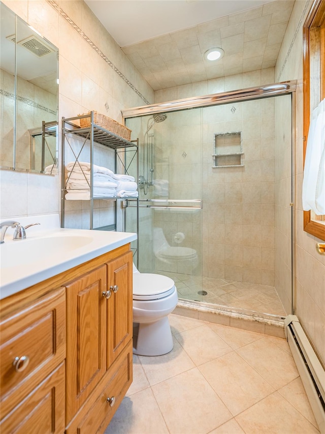 5023 213th St, Bayside, NY 11364 - full bathroom featuring a baseboard heating unit, tile walls, vanity, a stall shower, and tile patterned flooring