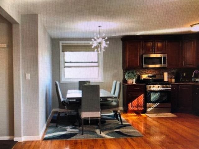 249-29 64th Ave Unit 2, Little Neck, NY 11362 - dining area with wood finished floors and a chandelier