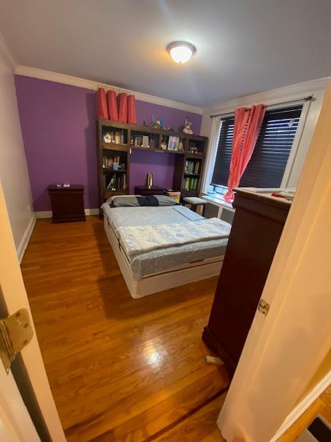 35-21 81st St Unit 1B, Jackson Heights, NY 11372 - bedroom featuring wood finished floors and ornamental molding