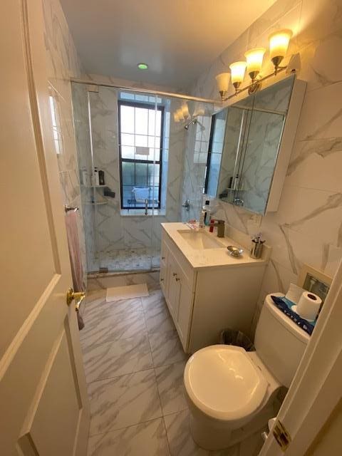 35-21 81st St Unit 1B, Jackson Heights, NY 11372 - full bathroom with marble finish flooring, vanity, and a marble finish shower