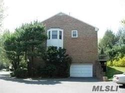 87 Marjorie Ct, Manhasset, NY 11030 - view of side of home featuring a garage and driveway
