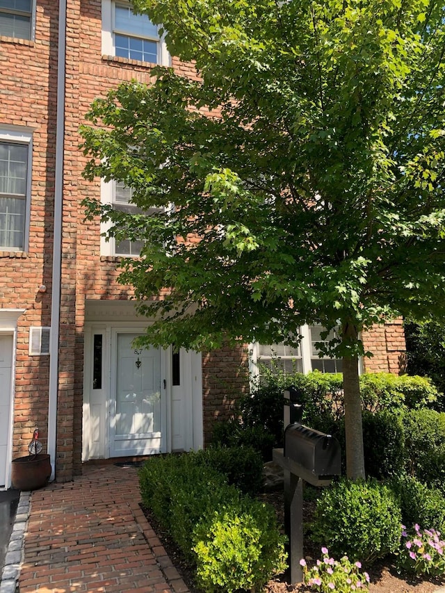 87 Marjorie Ct, Manhasset, NY 11030 - doorway to property featuring brick siding