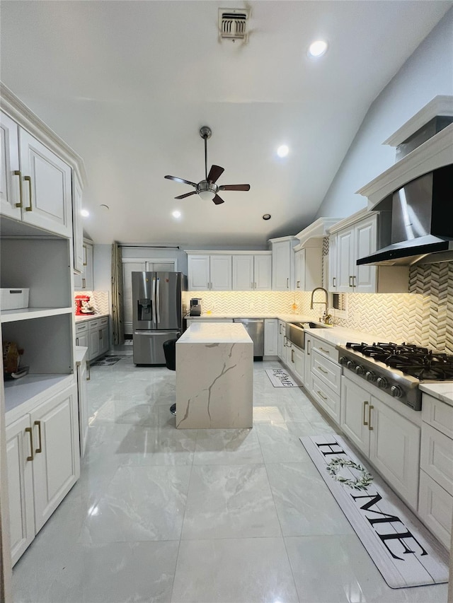 18 Sherwood Ln, Roslyn Heights, NY 11577 - kitchen featuring appliances with stainless steel finishes, wall chimney range hood, ceiling fan, a center island, and tasteful backsplash