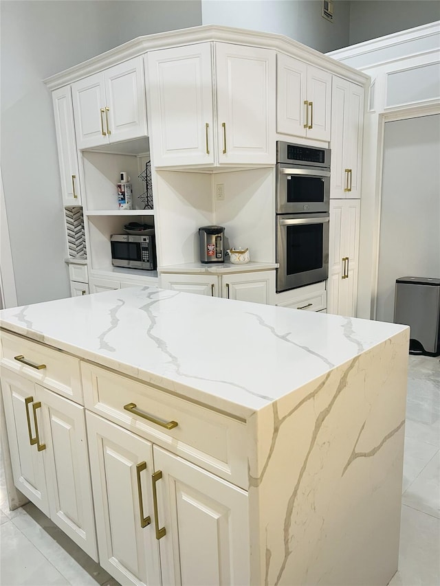 18 Sherwood Ln, Roslyn Heights, NY 11577 - kitchen with stainless steel appliances, light stone countertops, a kitchen island, and open shelves