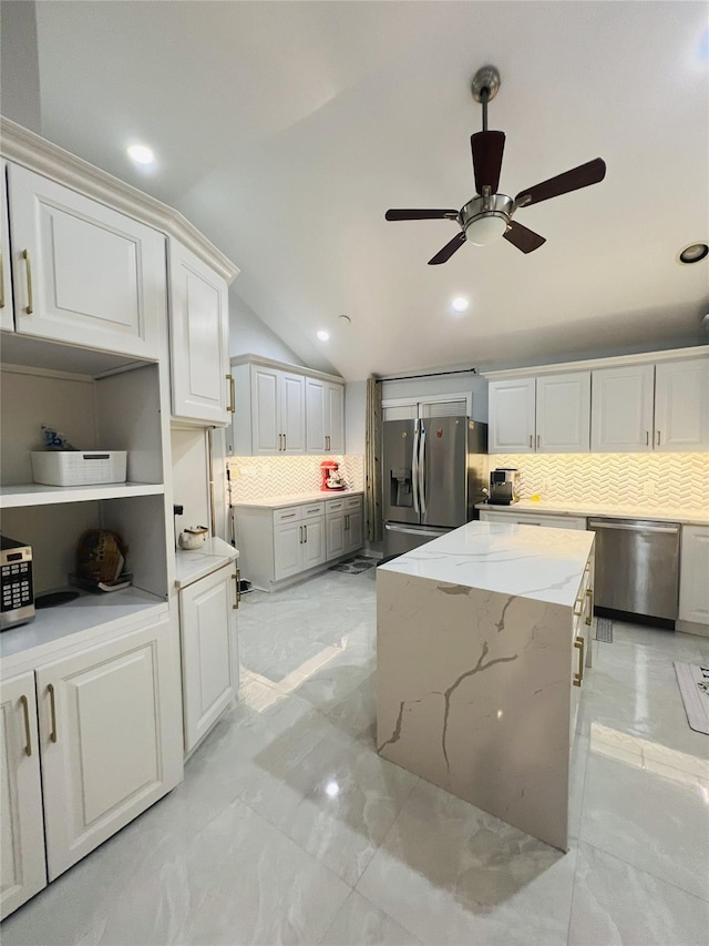 18 Sherwood Ln, Roslyn Heights, NY 11577 - kitchen with stainless steel appliances, tasteful backsplash, a ceiling fan, light marble finish floors, and light stone counters