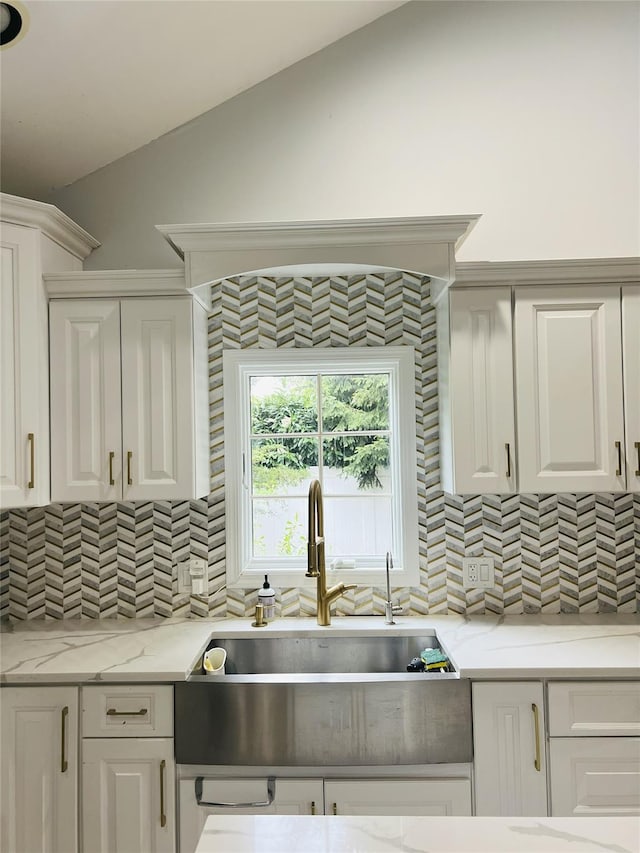18 Sherwood Ln, Roslyn Heights, NY 11577 - kitchen with tasteful backsplash, white cabinetry, vaulted ceiling, and light stone counters