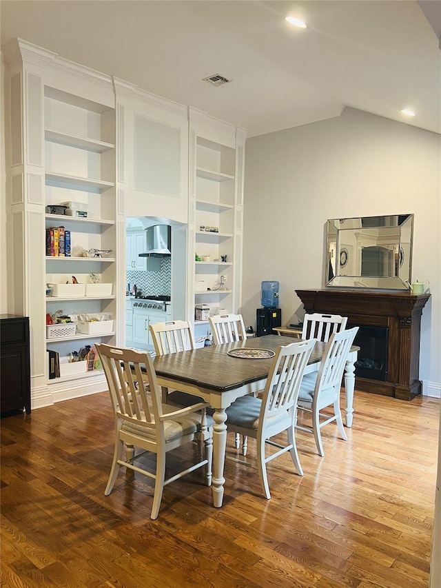 18 Sherwood Ln, Roslyn Heights, NY 11577 - dining area featuring wood finished floors, lofted ceiling, and recessed lighting