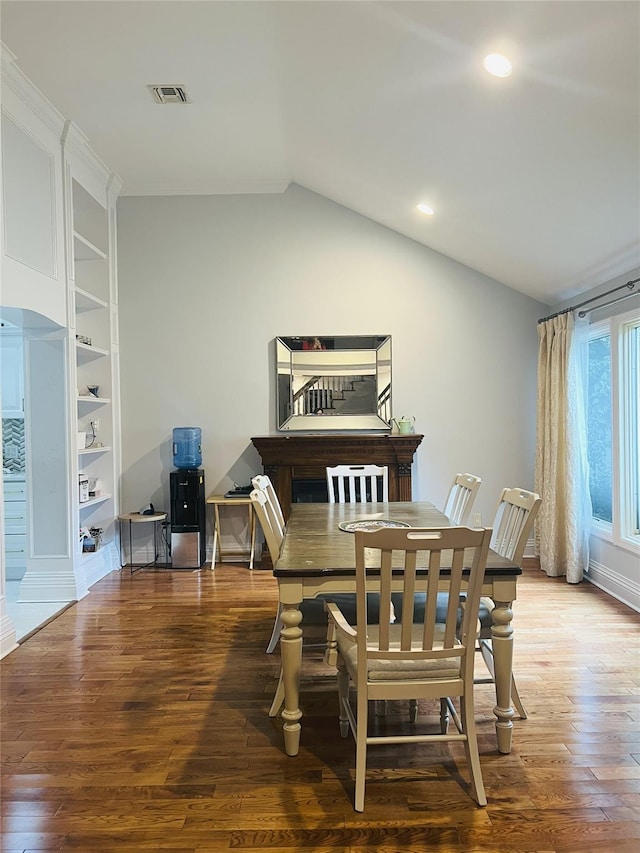 18 Sherwood Ln, Roslyn Heights, NY 11577 - dining area with lofted ceiling, wood finished floors, recessed lighting, and built in features