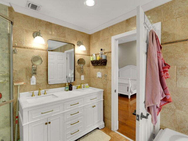 18 Sherwood Ln, Roslyn Heights, NY 11577 - full bathroom with tile walls, crown molding, double vanity, and a tile shower