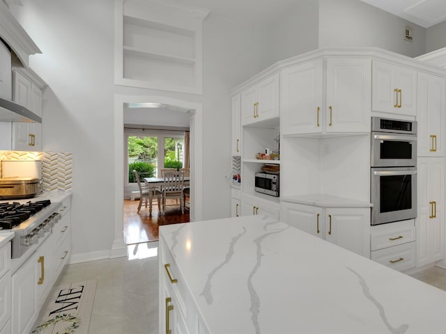 18 Sherwood Ln, Roslyn Heights, NY 11577 - kitchen with stainless steel appliances, a towering ceiling, white cabinetry, light stone counters, and open shelves