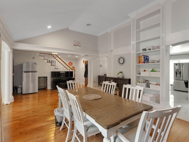 18 Sherwood Ln, Roslyn Heights, NY 11577 - dining room featuring stairway, ornate columns, light wood-style floors, built in features, and high vaulted ceiling