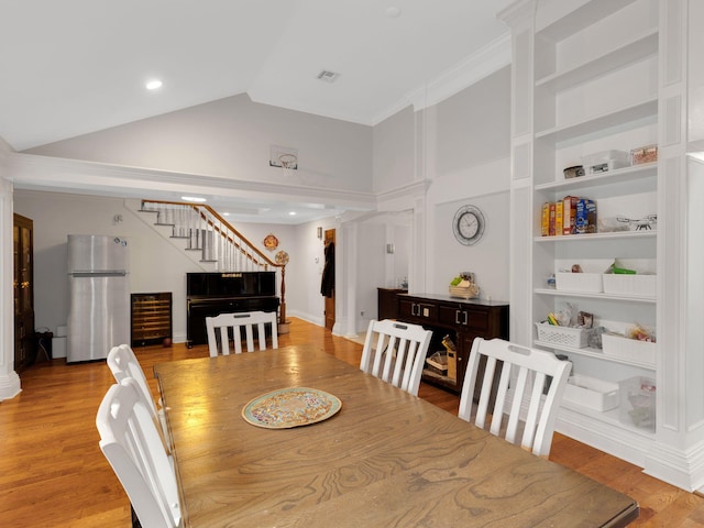 18 Sherwood Ln, Roslyn Heights, NY 11577 - dining room featuring stairs, beverage cooler, wood finished floors, high vaulted ceiling, and built in features