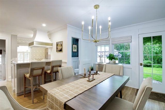 30 Prescott St, Garden City, NY 11530 - dining room featuring a chandelier, light wood-style floors, healthy amount of natural light, ornamental molding, and a decorative wall