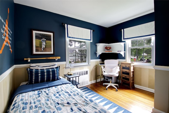 30 Prescott St, Garden City, NY 11530 - bedroom with radiator heating unit, wood finished floors, and wainscoting
