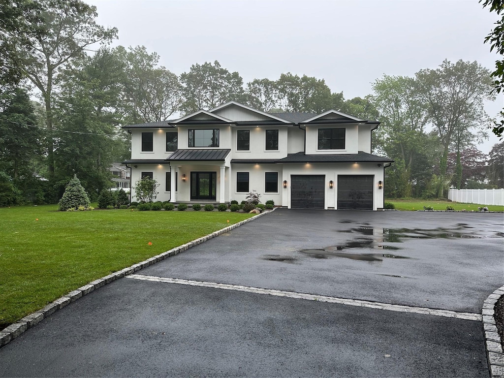 352 Cold Spring Rd, Syosset, NY 11791 - modern inspired farmhouse with stucco siding, an attached garage, and driveway