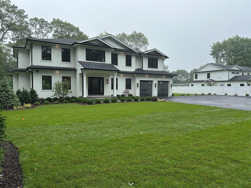 352 Cold Spring Rd, Syosset, NY 11791 - modern inspired farmhouse featuring driveway, an attached garage, stucco siding, and a standing seam roof