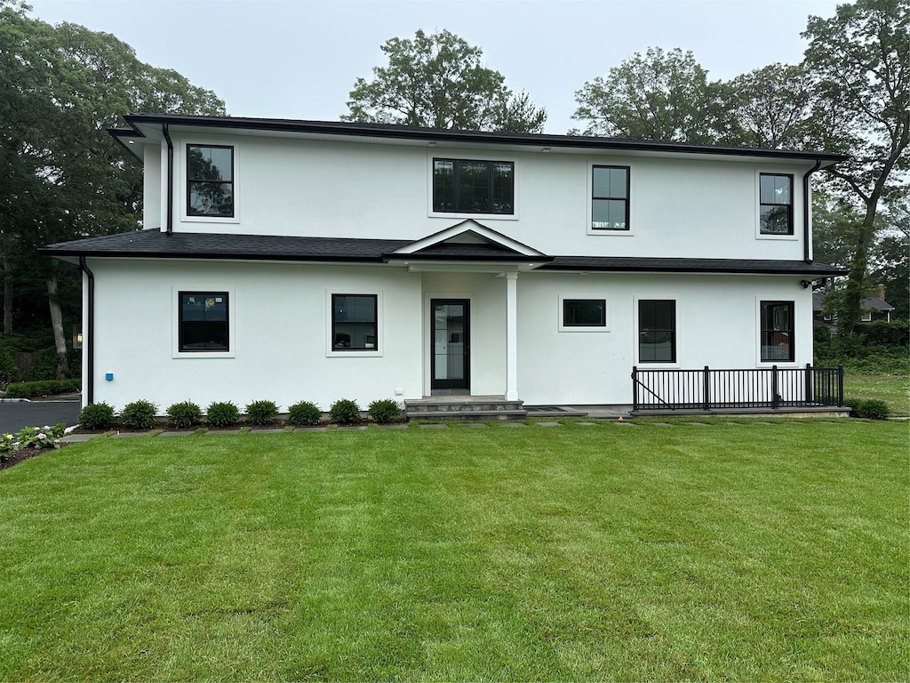 352 Cold Spring Rd, Syosset, NY 11791 - view of front facade with stucco siding and a front yard