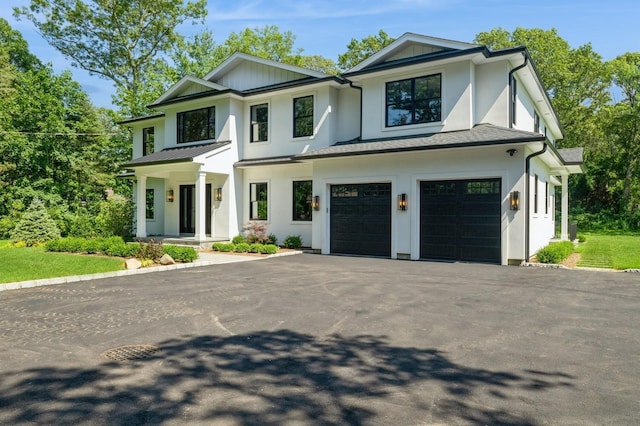 352 Cold Spring Rd, Syosset, NY 11791 - modern farmhouse with driveway, an attached garage, and stucco siding