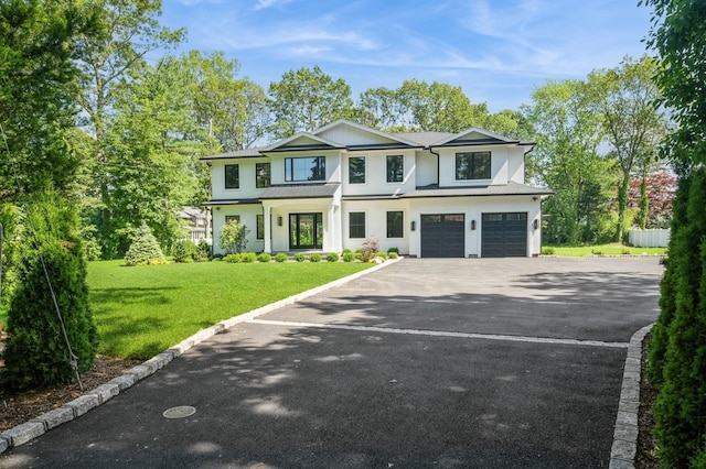 352 Cold Spring Rd, Syosset, NY 11791 - modern farmhouse with driveway, a garage, stucco siding, and a front lawn