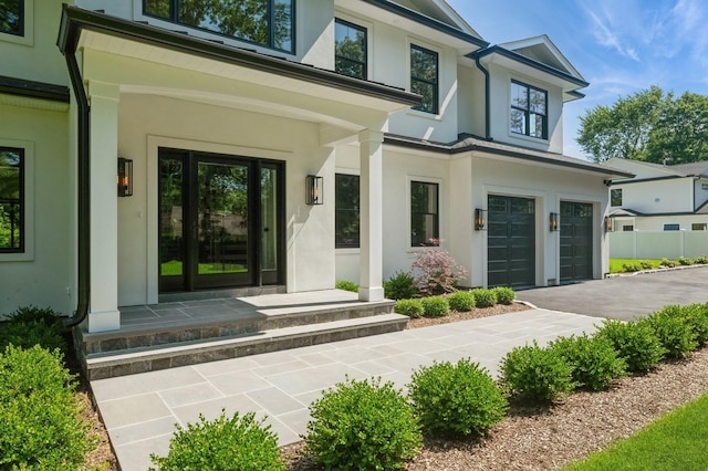 352 Cold Spring Rd, Syosset, NY 11791 - entrance to property with stucco siding, an attached garage, driveway, and a porch