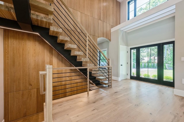 352 Cold Spring Rd, Syosset, NY 11791 - foyer entrance featuring a towering ceiling, arched walkways, stairs, and wood finished floors
