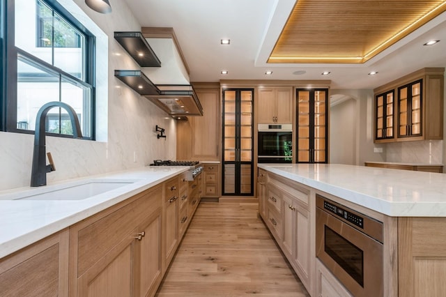 352 Cold Spring Rd, Syosset, NY 11791 - kitchen with stainless steel appliances, glass insert cabinets, light stone countertops, light wood-style flooring, and recessed lighting