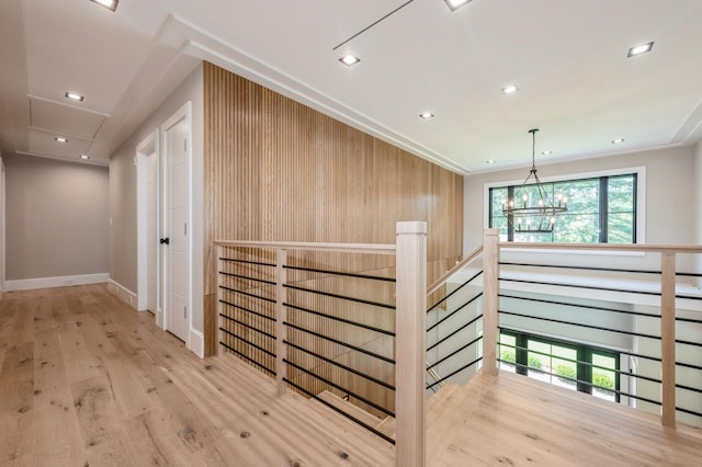 352 Cold Spring Rd, Syosset, NY 11791 - hall with an upstairs landing, wood finished floors, attic access, wooden walls, and recessed lighting