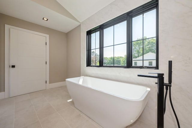 352 Cold Spring Rd, Syosset, NY 11791 - full bath featuring a freestanding bath, vaulted ceiling, and tile patterned floors