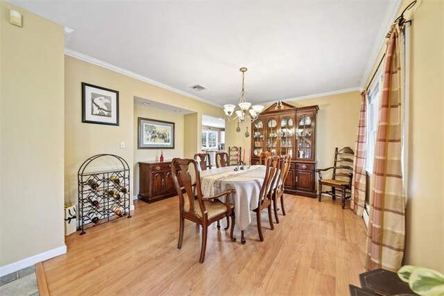 1 Cindy Ln, Highland Mills, NY 10930 - dining area with a chandelier, light wood-type flooring, and crown molding