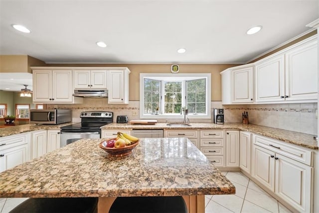 1 Cindy Ln, Highland Mills, NY 10930 - kitchen with stainless steel appliances, under cabinet range hood, light stone counters, tasteful backsplash, and recessed lighting