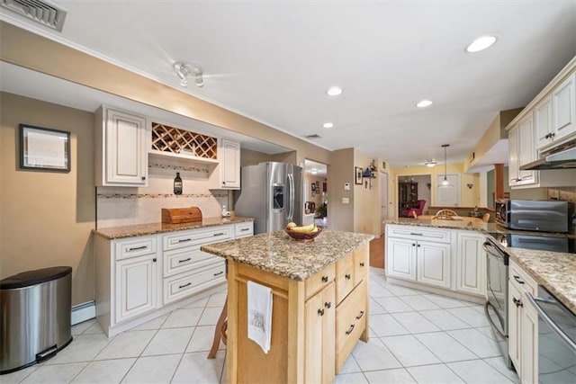 1 Cindy Ln, Highland Mills, NY 10930 - kitchen with appliances with stainless steel finishes, a baseboard radiator, a peninsula, light tile patterned floors, and recessed lighting