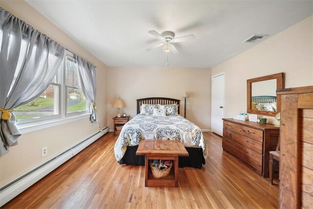 1 Cindy Ln, Highland Mills, NY 10930 - bedroom with a baseboard heating unit, wood finished floors, and a ceiling fan
